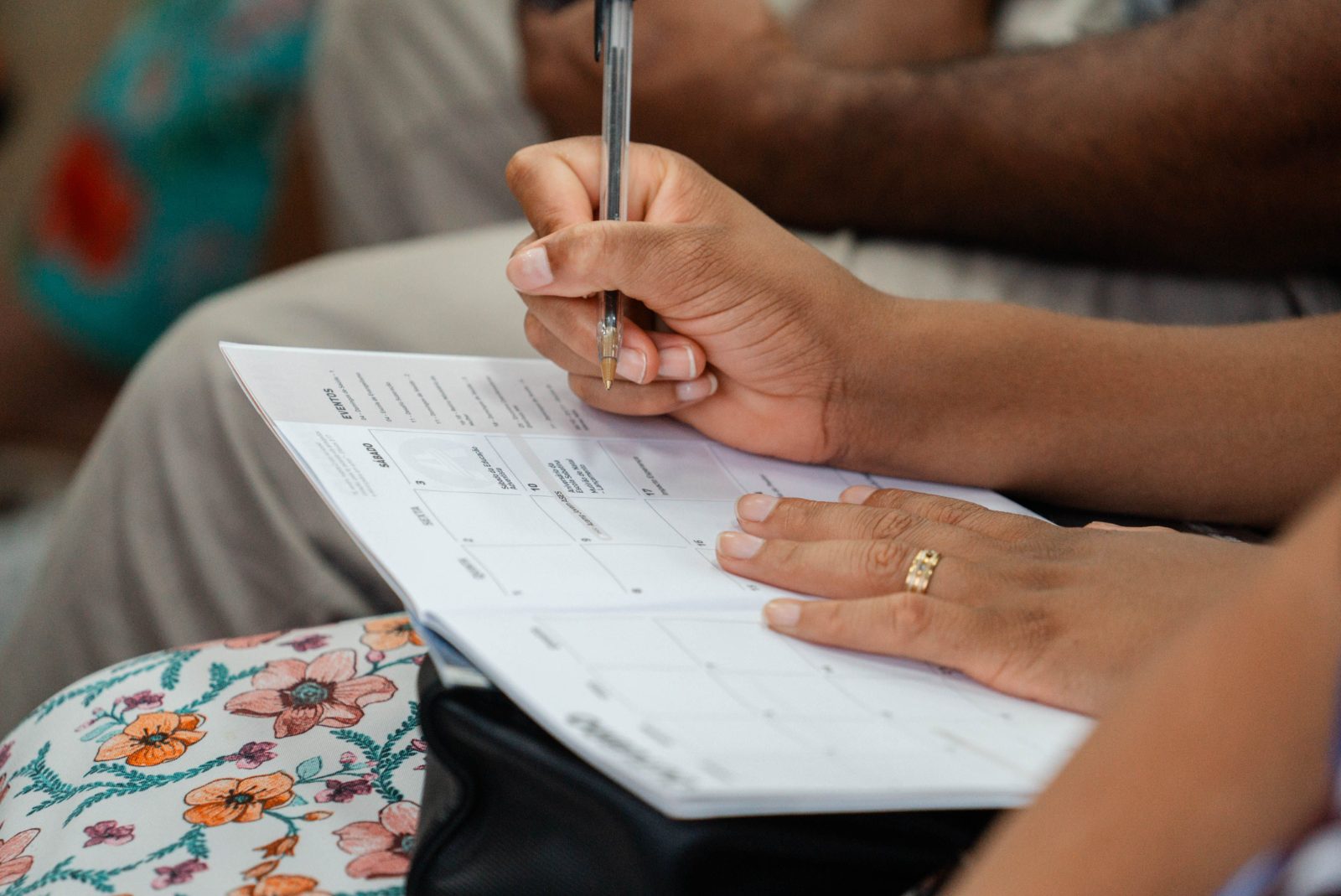 Hands resting on a paper calendar