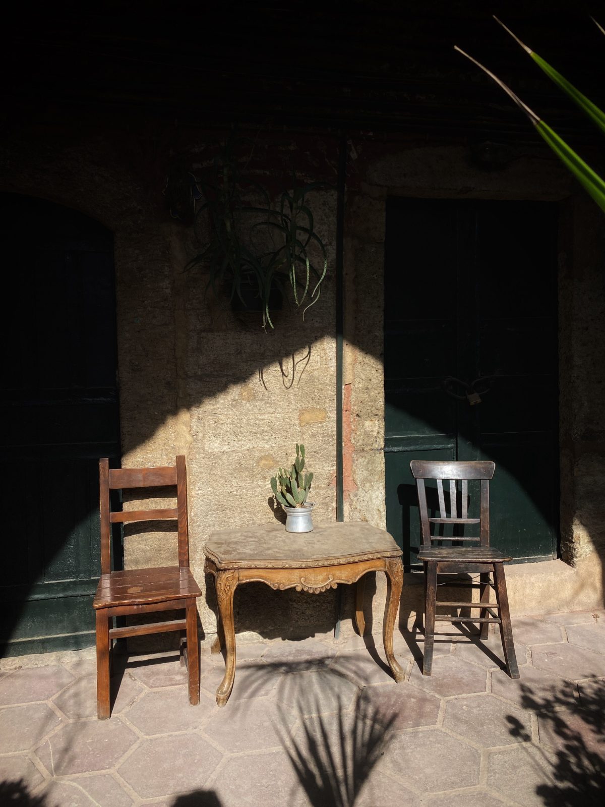 Two chairs side by side in a courtyard